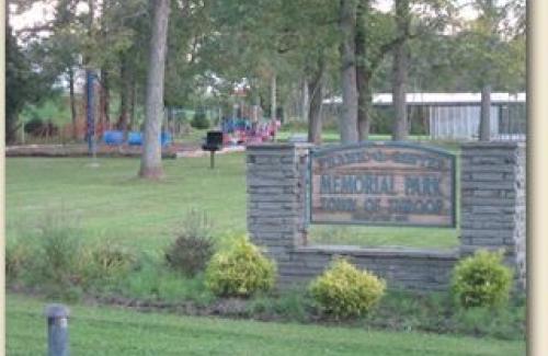 Sawyer Park entrance sign, playground, lawn and pavilion